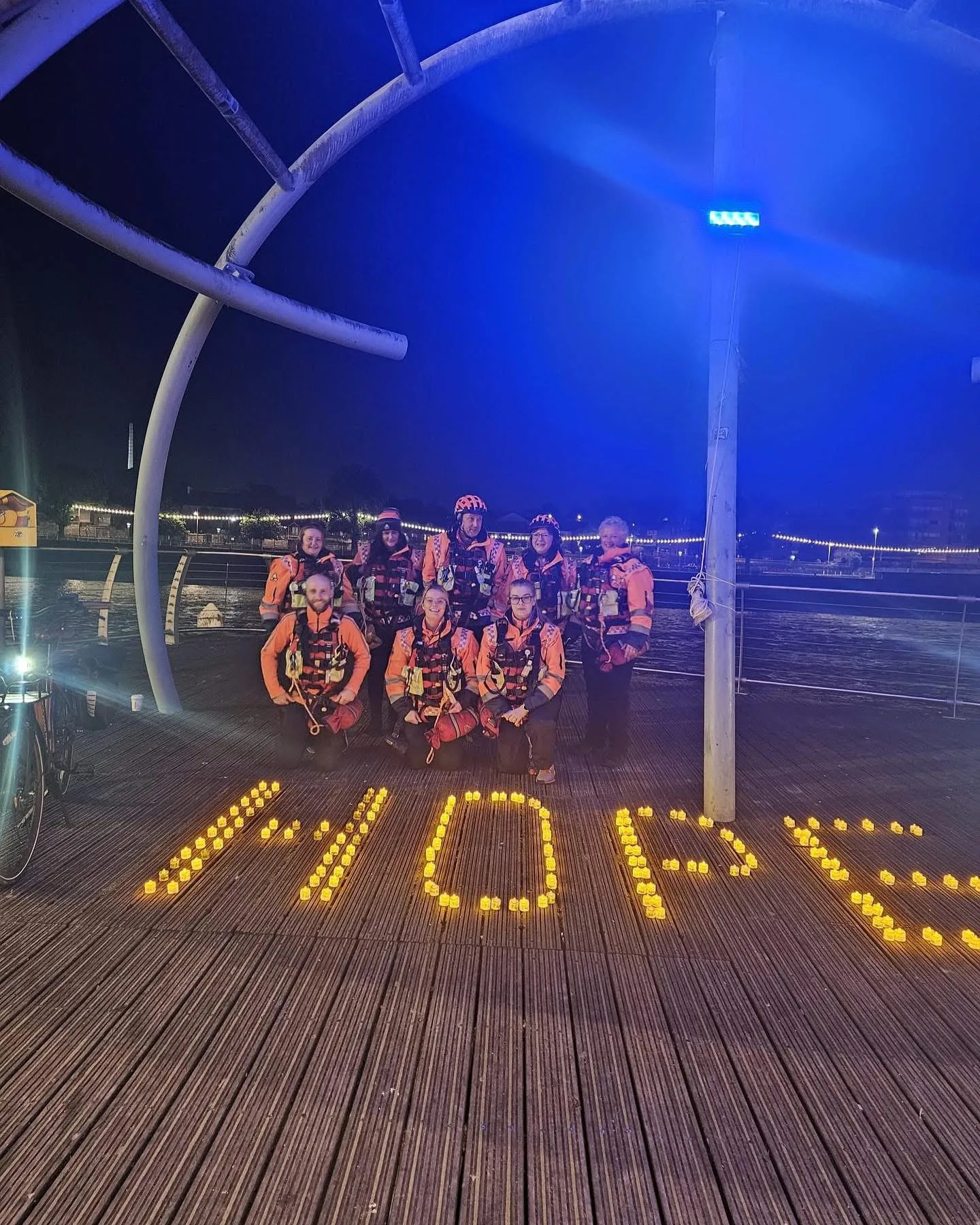 LSW members beside HOPE candle display